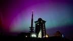 Northern lights appear in the night sky above the Brocken 